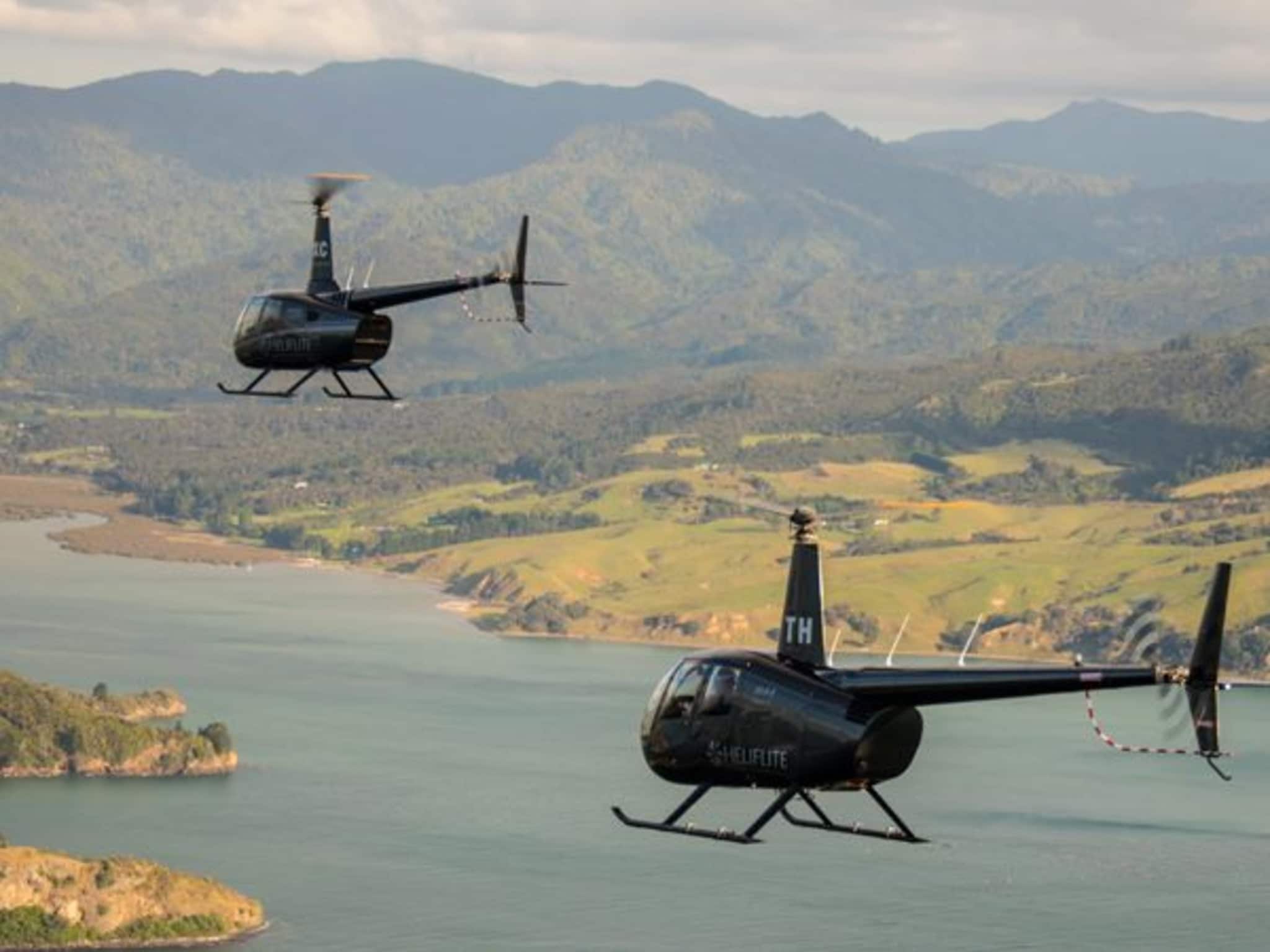 Heliflite helicopter parked with scenic New Zealand backdrop